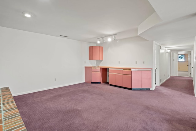 kitchen with light countertops, carpet, visible vents, and baseboards