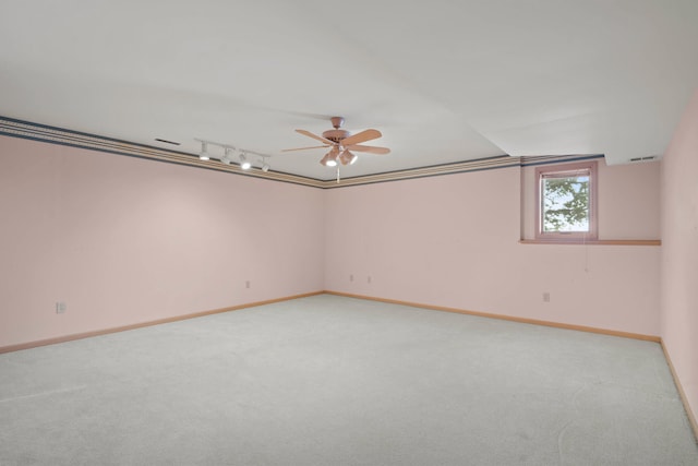 spare room with baseboards, carpet floors, a ceiling fan, and track lighting