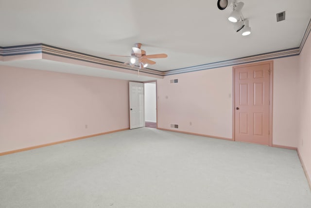 unfurnished bedroom featuring baseboards, visible vents, crown molding, and light colored carpet