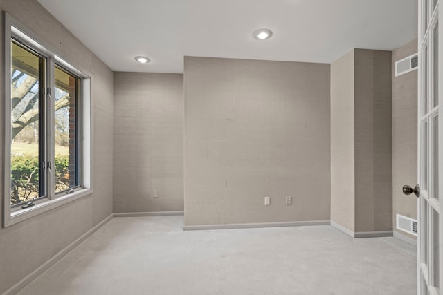 empty room with baseboards, visible vents, and carpet flooring