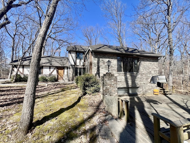 view of side of home featuring brick siding