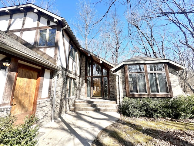 view of side of home with brick siding and stucco siding