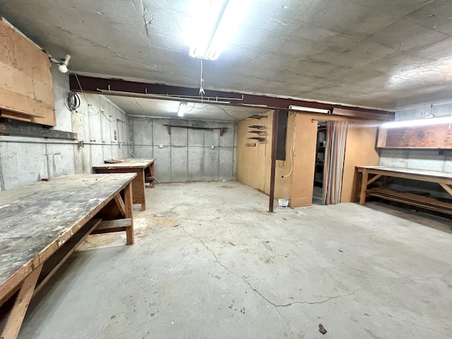 unfinished basement with a workshop area