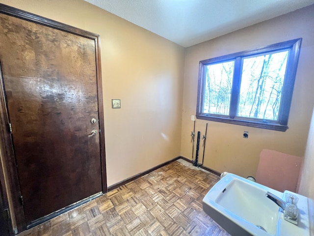 bathroom featuring a sink and baseboards