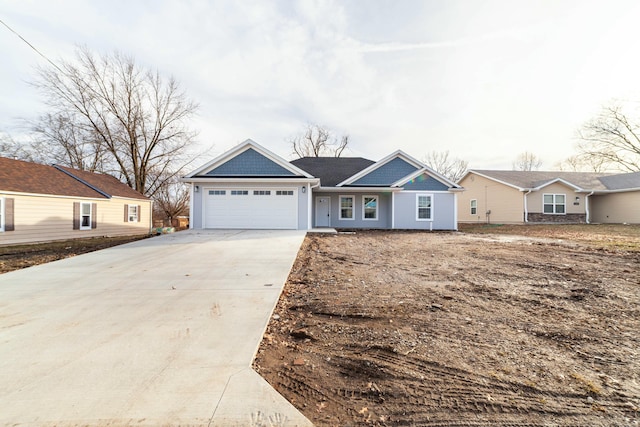 ranch-style house featuring concrete driveway and an attached garage