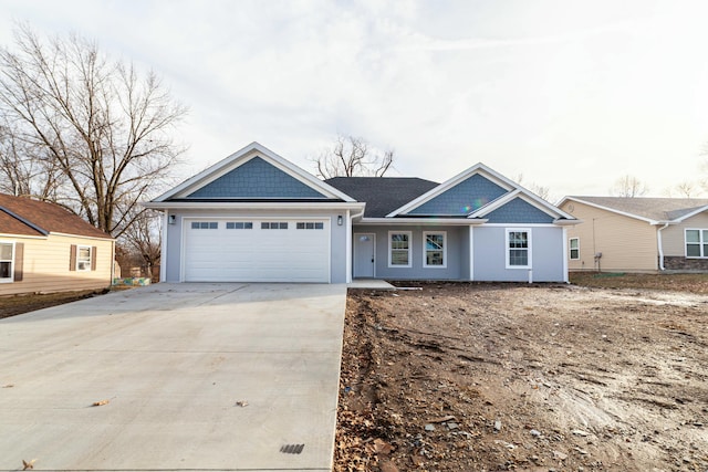 view of front facade with a garage, driveway, and stucco siding