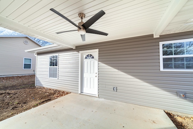 property entrance with a ceiling fan and a patio