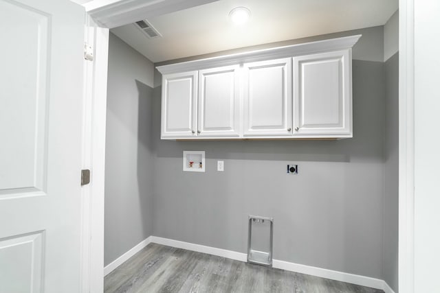 laundry area featuring washer hookup, visible vents, baseboards, cabinet space, and electric dryer hookup