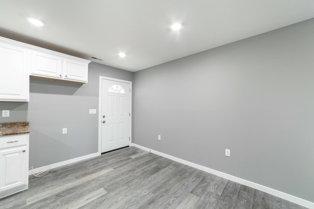 interior space featuring light wood-style flooring, visible vents, baseboards, and recessed lighting