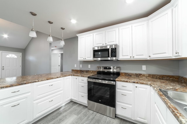 kitchen with white cabinets, light wood-style flooring, appliances with stainless steel finishes, hanging light fixtures, and a sink