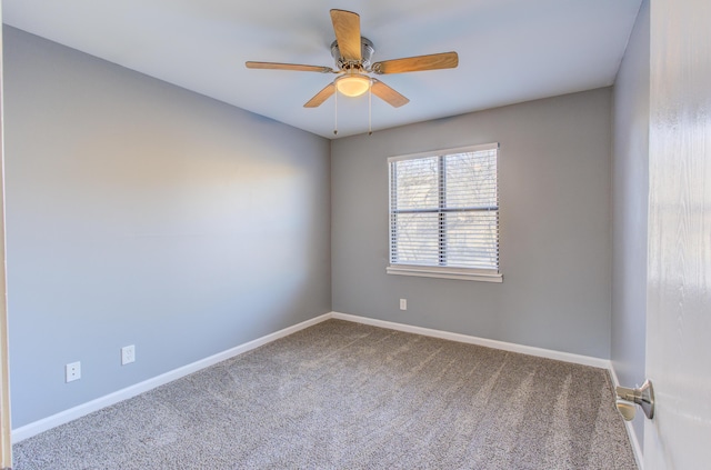 carpeted empty room featuring a ceiling fan and baseboards