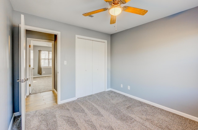 unfurnished bedroom featuring a closet, carpet flooring, ceiling fan, and baseboards