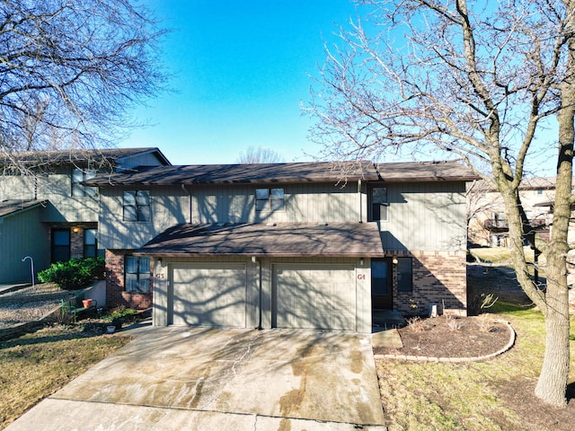 view of front of property featuring a garage, concrete driveway, and brick siding