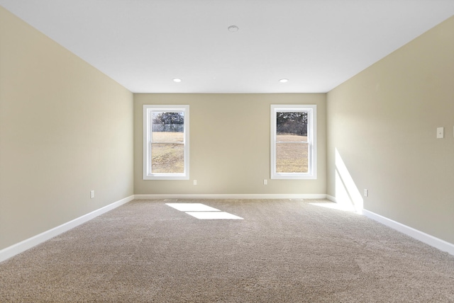 carpeted spare room with baseboards, a wealth of natural light, and recessed lighting