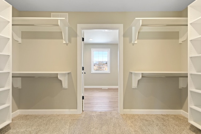 walk in closet featuring carpet flooring and visible vents