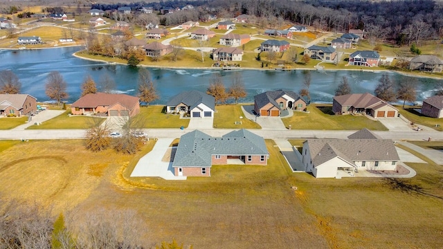 drone / aerial view with a water view and a residential view