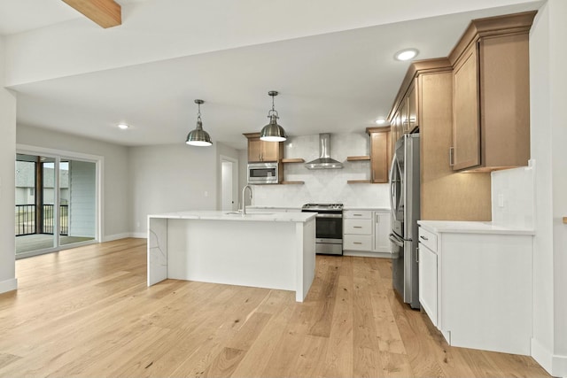 kitchen with tasteful backsplash, light wood-style flooring, appliances with stainless steel finishes, wall chimney range hood, and open shelves