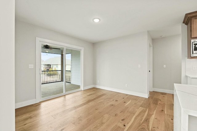 spare room with light wood-type flooring and baseboards