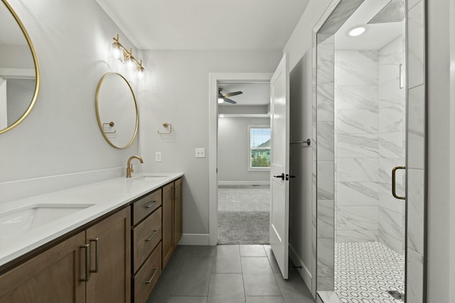 bathroom featuring a sink, baseboards, tile patterned floors, double vanity, and a stall shower