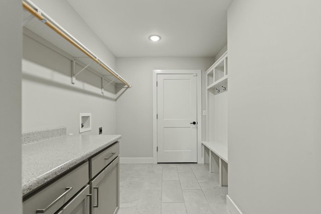 clothes washing area featuring light tile patterned flooring, hookup for a washing machine, baseboards, cabinet space, and electric dryer hookup