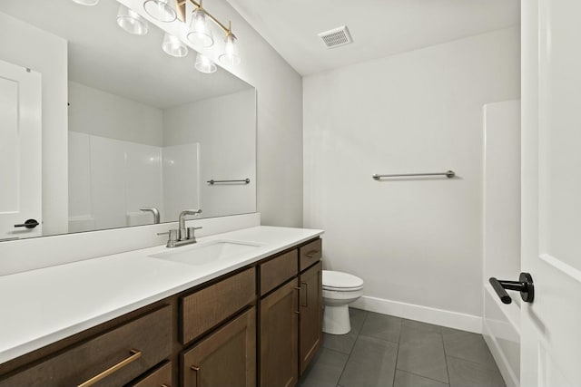 bathroom featuring visible vents, toilet, vanity, baseboards, and tile patterned floors