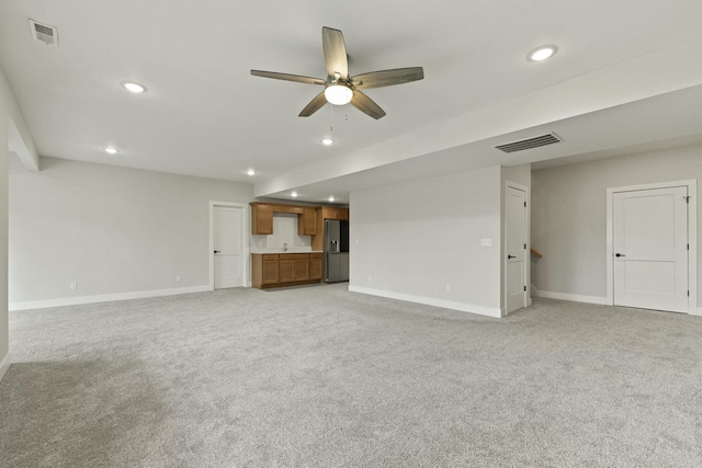 unfurnished living room with recessed lighting, visible vents, light carpet, and baseboards