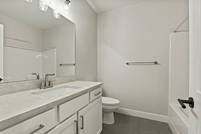 bathroom with tile patterned flooring, baseboards, vanity, and toilet