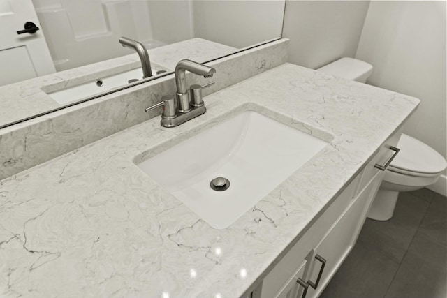 bathroom featuring vanity, toilet, and tile patterned floors