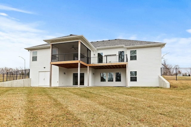 back of property with a lawn, fence, and a ceiling fan