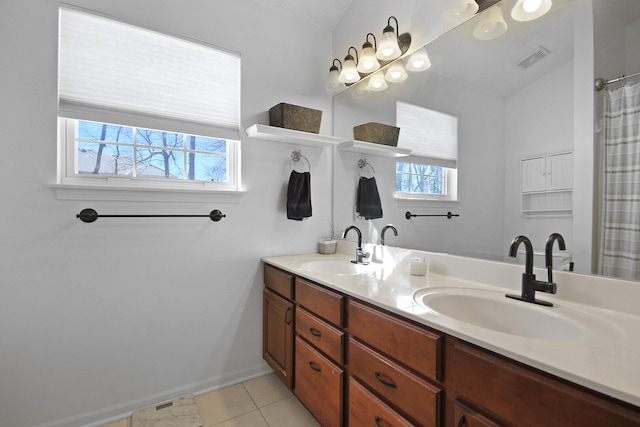 bathroom with double vanity, tile patterned flooring, visible vents, and a sink