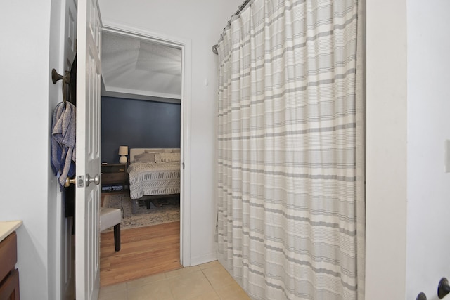 bathroom with tile patterned flooring, vanity, and a shower with curtain