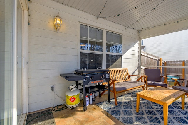 view of patio with a grill and fence