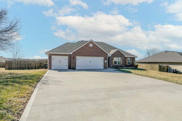 view of front of home featuring concrete driveway, an attached garage, fence, a front lawn, and brick siding