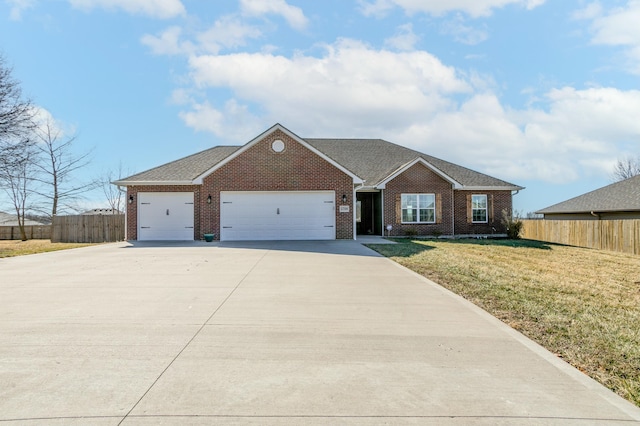 single story home featuring brick siding, a front lawn, an attached garage, and fence