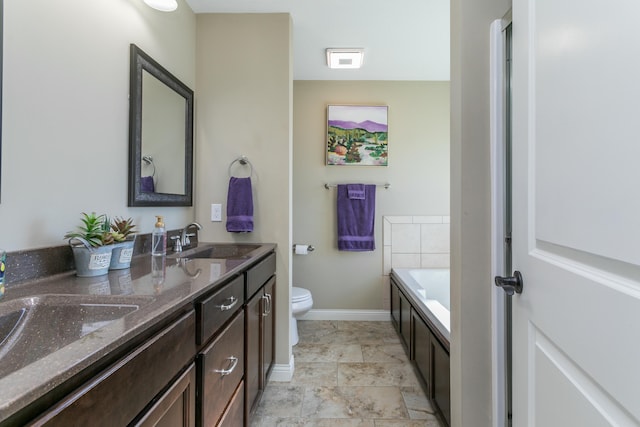 full bathroom with a garden tub, a sink, toilet, and baseboards