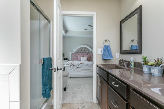 full bathroom featuring connected bathroom, a stall shower, a sink, and double vanity