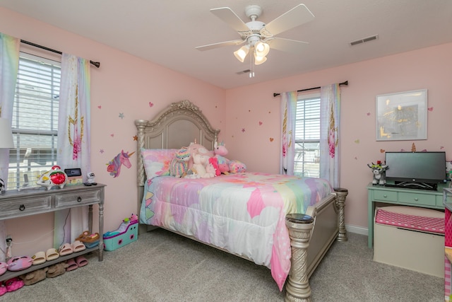 carpeted bedroom with a ceiling fan and visible vents