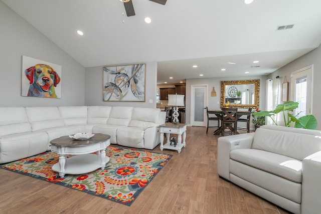 living room with visible vents, ceiling fan, vaulted ceiling, light wood-style floors, and recessed lighting