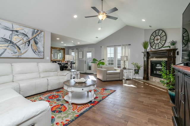 living room with lofted ceiling, recessed lighting, a premium fireplace, ceiling fan, and wood finished floors