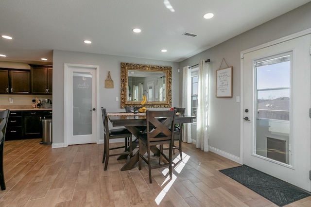 dining room featuring light wood-type flooring, visible vents, baseboards, and recessed lighting