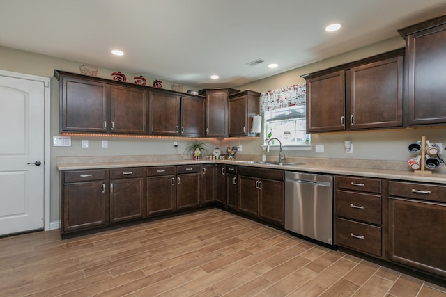 kitchen featuring a sink, dark brown cabinets, light countertops, and dishwasher