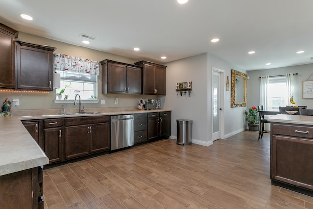 kitchen featuring dark brown cabinetry, a sink, visible vents, light wood-type flooring, and dishwasher