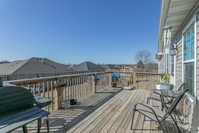 wooden deck featuring a residential view and fence