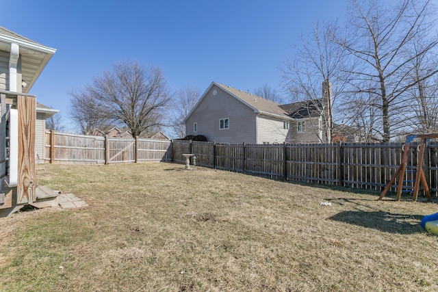 view of yard with a fenced backyard and a playground