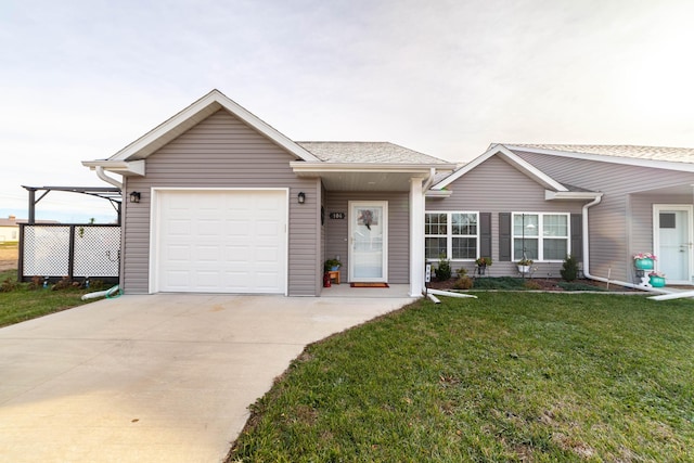 ranch-style home featuring a garage, a front yard, and driveway