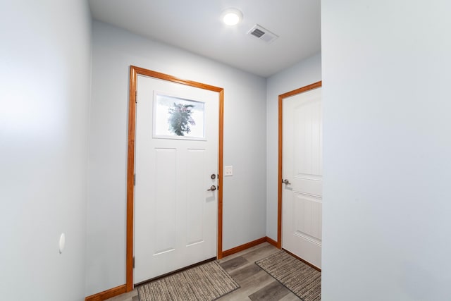 interior space featuring light wood-style floors, baseboards, and visible vents