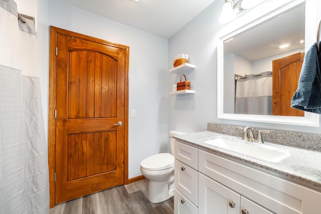 full bath with vanity, wood finished floors, toilet, and a shower with curtain