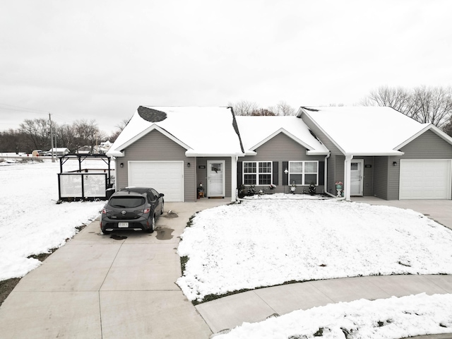 ranch-style home featuring a garage and driveway