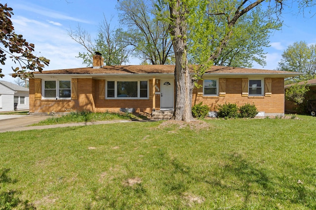 ranch-style home with a front yard, a chimney, and brick siding