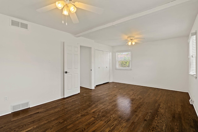 unfurnished bedroom with a ceiling fan, visible vents, dark wood-style flooring, and beamed ceiling